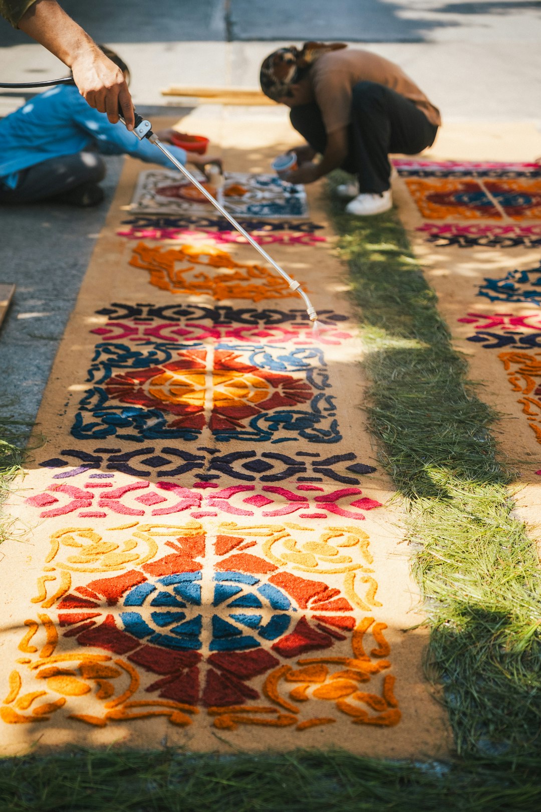 people-create-colorful-carpets-on-the-ground-ptv6tmmtnfs
